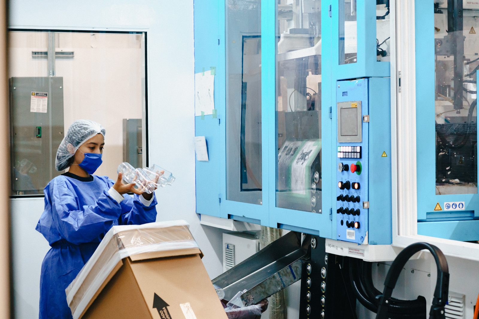 Gown, hairnet and face mask at the machine