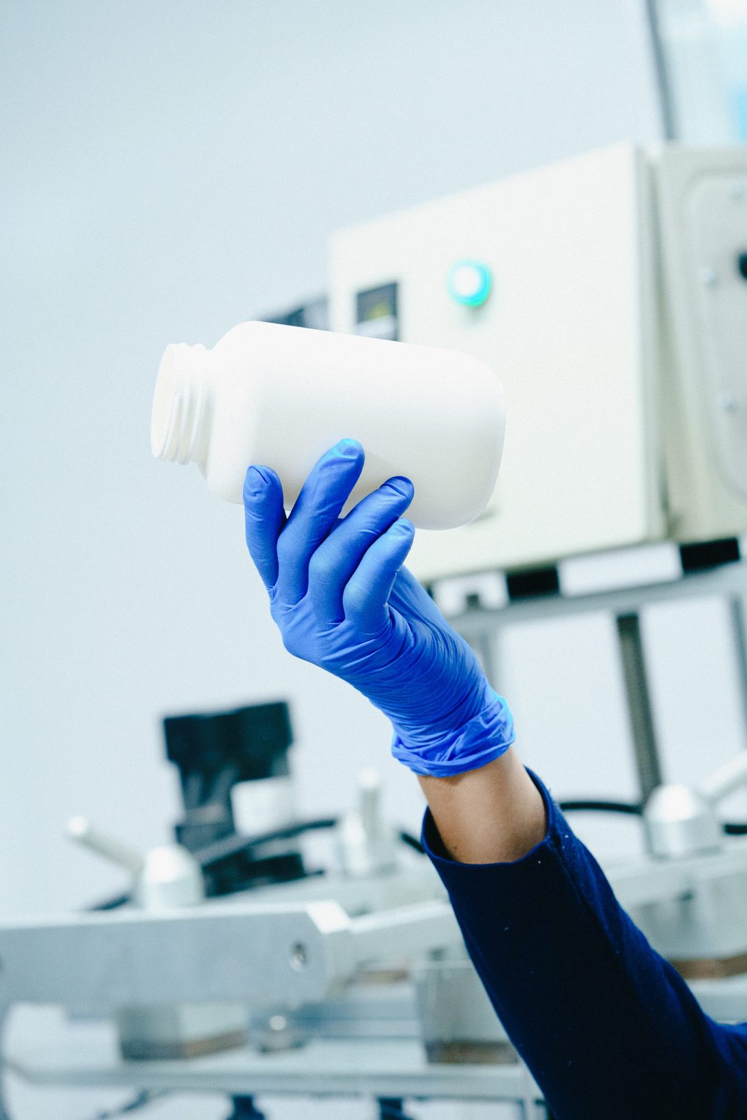 Wide-mouth bottle checked with a nitrile glove